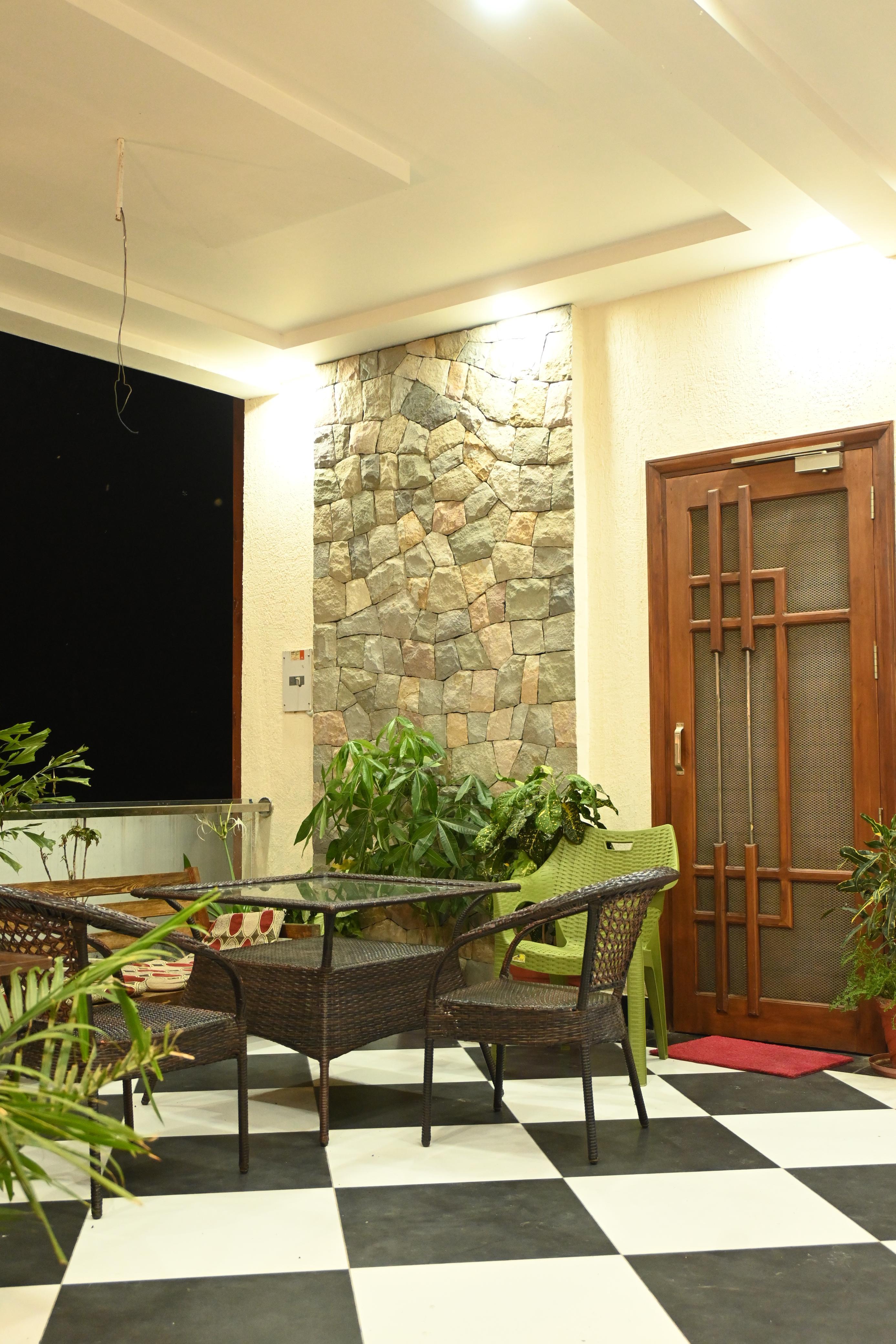 Warmly lit courtyard seating area at Phulsani Chitwan Retreat in the evening
